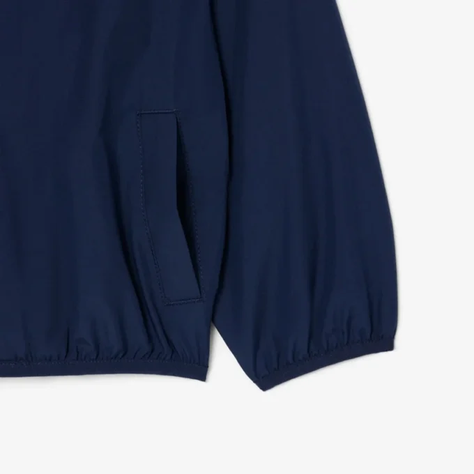 Cortavientos unisex con capucha