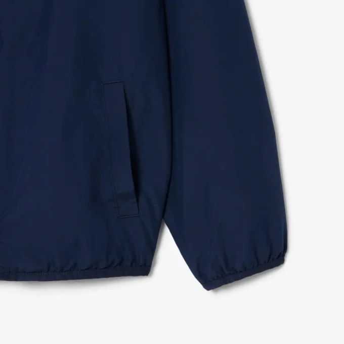 Cortavientos unisex con capucha