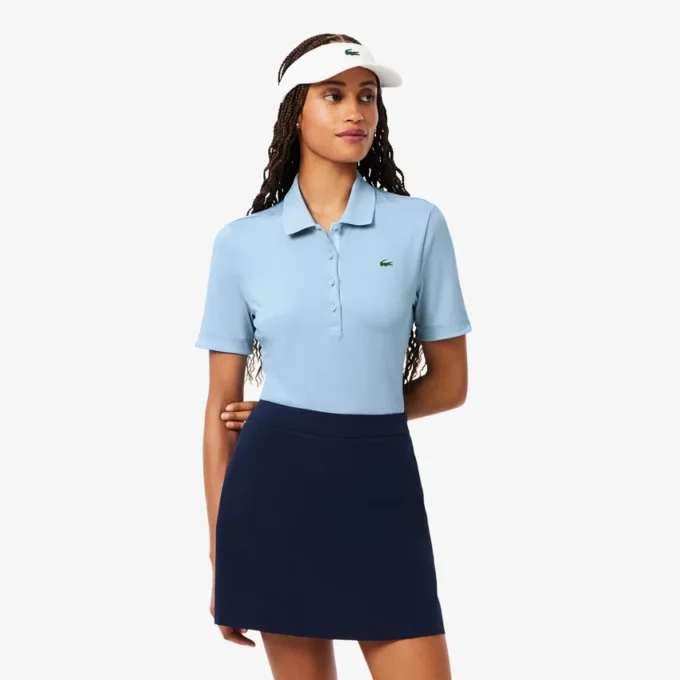 Polo de golf elástico con protección UV y corte entallado para mujer