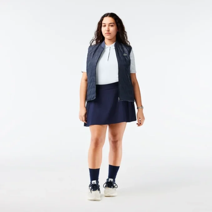 Polo de golf elástico con protección UV y corte entallado para mujer