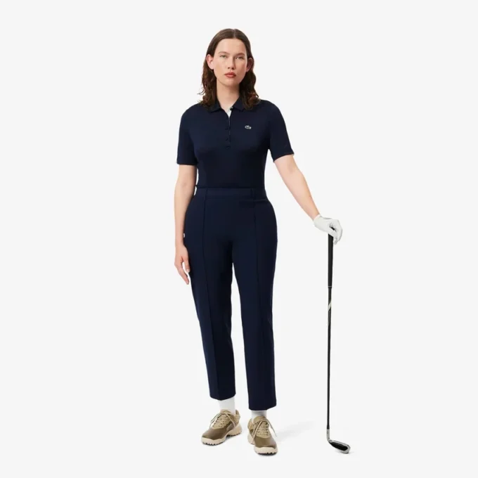 Polo de golf elástico con protección UV y corte entallado para mujer
