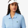 Polo de golf elástico con protección UV y corte entallado para mujer