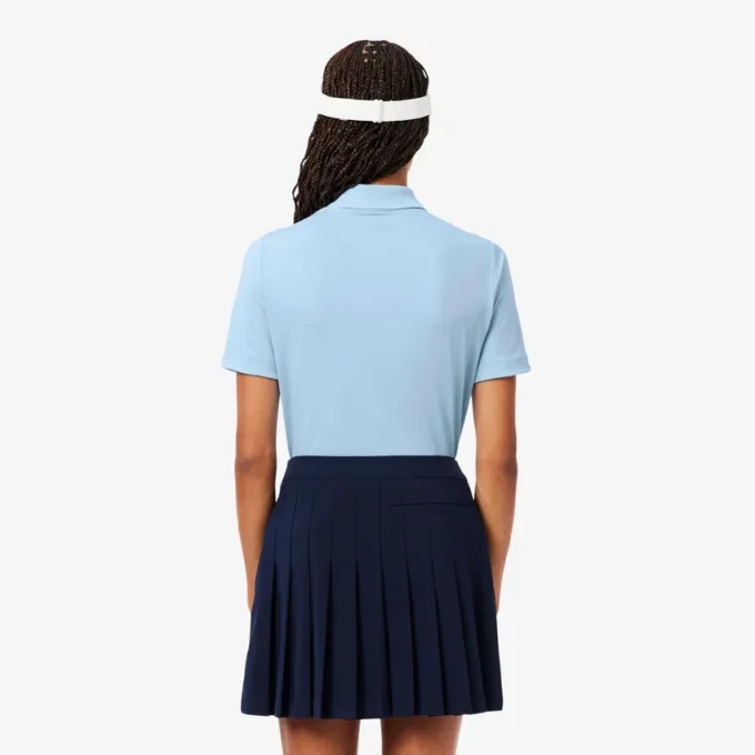 Polo de golf elástico con protección UV y corte entallado para mujer