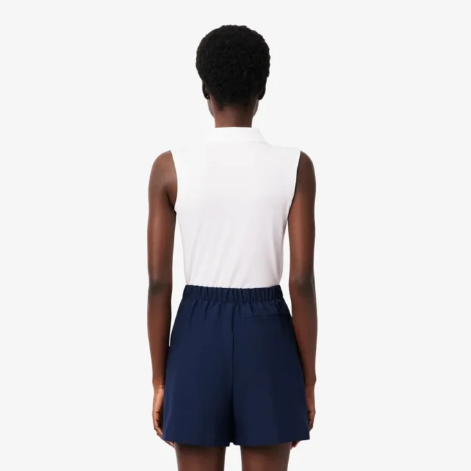 Polo de golf elástico con protección UV y corte entallado para mujer