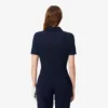Polo de golf elástico con protección UV y corte entallado para mujer
