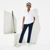 Polo de golf elástico con protección UV y corte entallado para mujer
