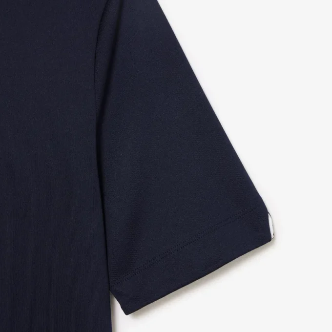 Polo de golf elástico con protección UV y corte entallado para mujer