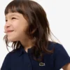 Polo de piqué con cuello festoneado para niña