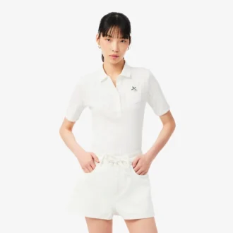 Polo L.12.D de mujer, corte entallado y con el logotipo en punto calado