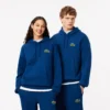 Sudadera con capucha unisex de corte holgado y detalle de insignia