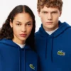 Sudadera con capucha unisex de corte holgado y detalle de insignia