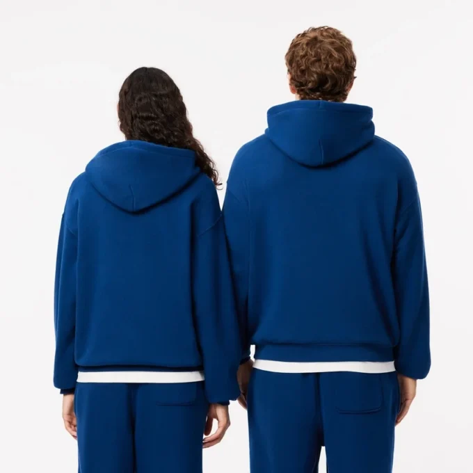 Sudadera con capucha unisex de corte holgado y detalle de insignia