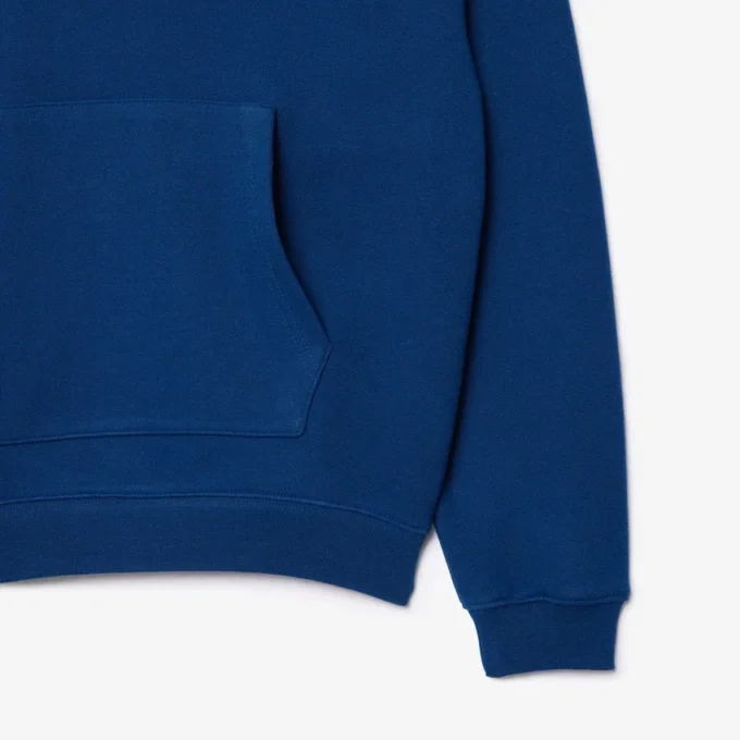 Sudadera con capucha unisex de corte holgado y detalle de insignia
