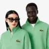 Sudadera unisex de corte holgado con detalle de insignia y media cremallera