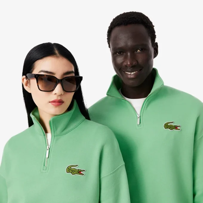 Sudadera unisex de corte holgado con detalle de insignia y media cremallera